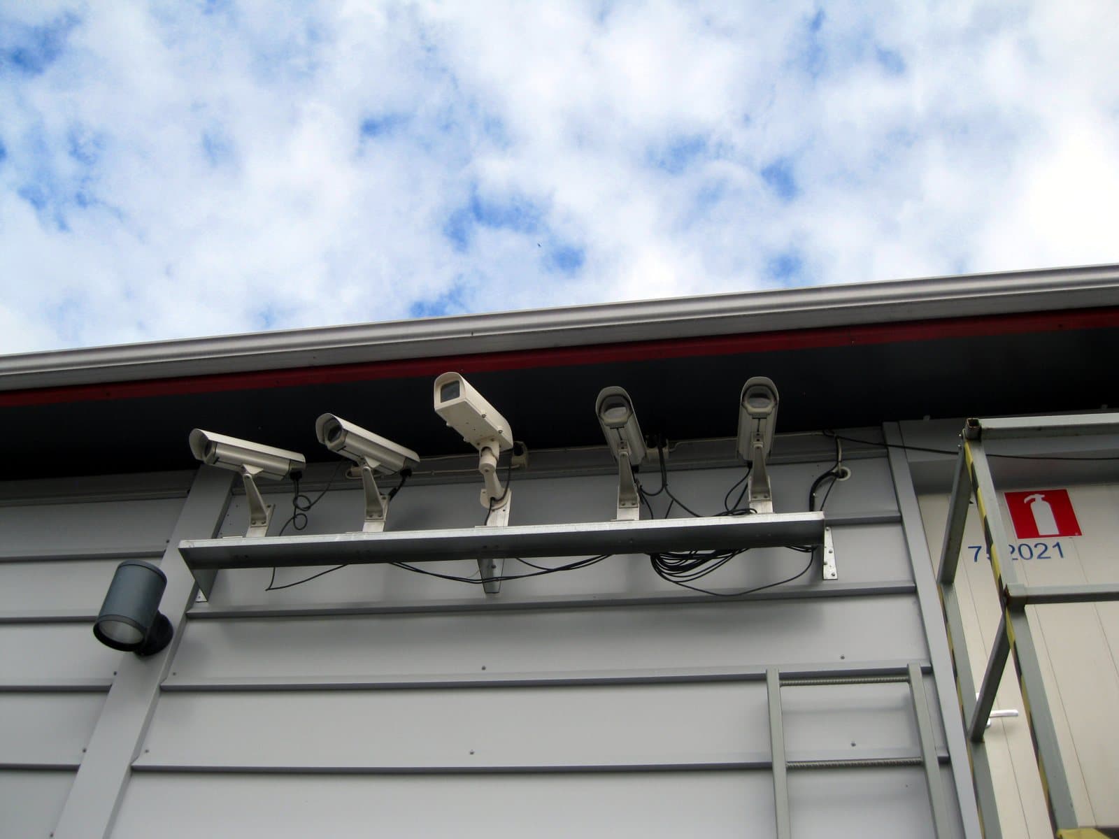 A group of security cameras mounted together outdoors.
